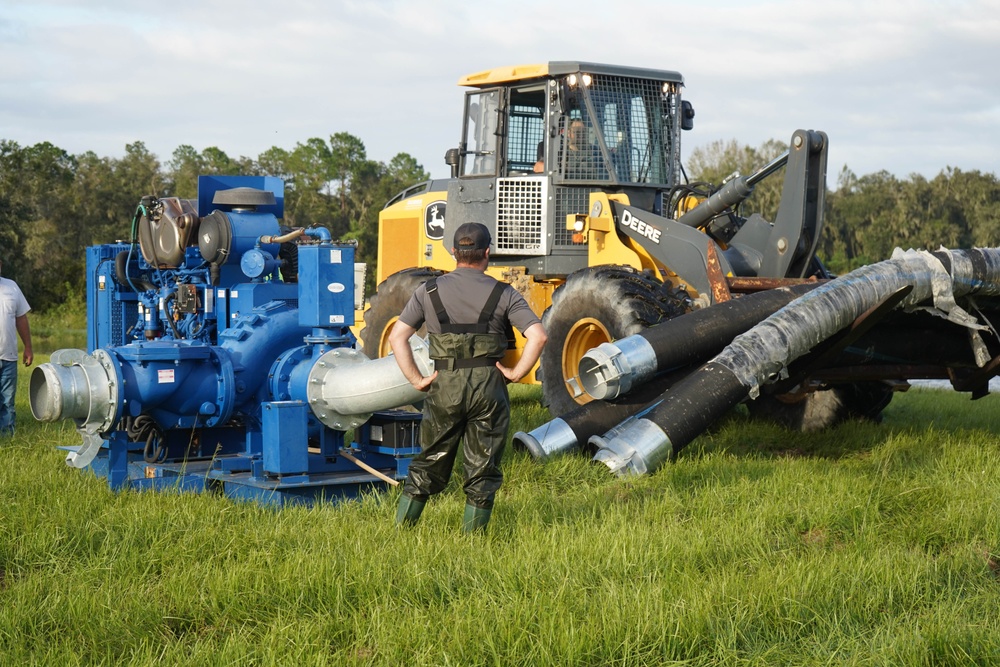 U.S. Army Corps of Engineers and South Florida Water Management work tirelessly to set up a pump system at Medard Reservoir to aid the flow of water to prevent flooding following Hurricane Milton on Oct. 10, 2024.