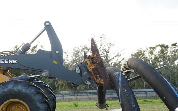 U.S. Army Corps of Engineers and South Florida Water Management work tirelessly to set up a pump system at Medard Reservoir to aid the flow of water to prevent flooding following Hurricane Milton on Oct. 10, 2024.