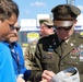 Army Reserve Soldier and country music star Craig Morgan performs the National Anthem alongside the 313th Army Band at the YellaWood 500