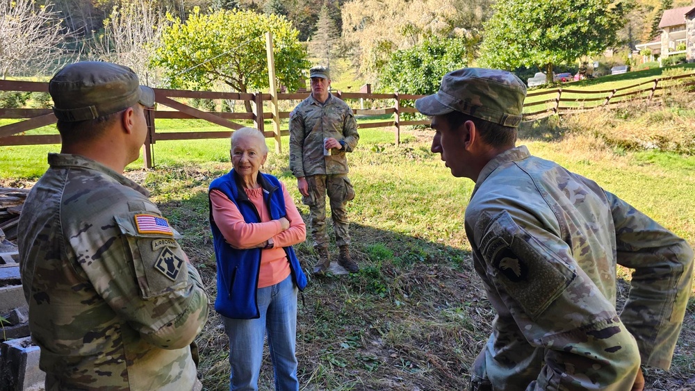 Screaming Eagles fix a fence and remove wreckage for a local citizen