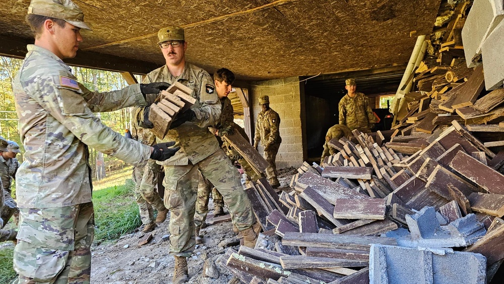 Screaming Eagles fix a fence and remove wreckage for a local citizen