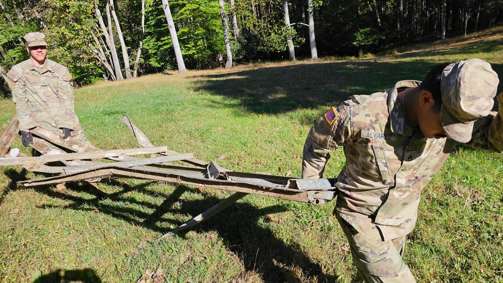 Screaming Eagles fix a fence and remove wreckage for a local citizen