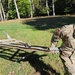 Screaming Eagles fix a fence and remove wreckage for a local citizen