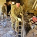 Screaming Eagles fix a fence and remove wreckage for a local citizen