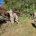 Screaming Eagles fix a fence and remove wreckage for a local citizen