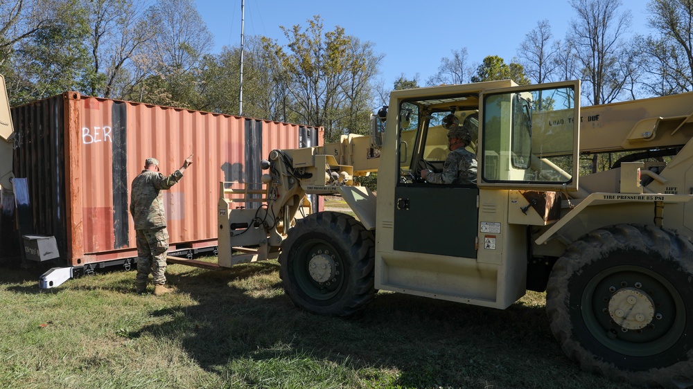 135th Forward Sustainment Support Company, 3-27 Field Artillery Regiment unload supplies in Marion, North Carolina