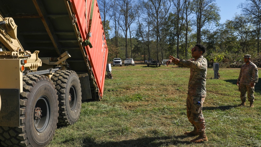 135th Forward Sustainment Support Company, 3-27 Field Artillery Regiment unload supplies in Marion, North Carolina