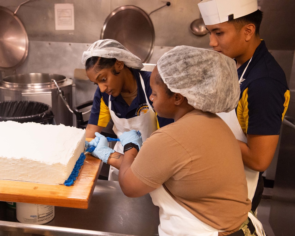 USS John C. Stennis (CVN 74) Sailors decorate 249th Navy birthday cake