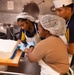 USS John C. Stennis (CVN 74) Sailors decorate 249th Navy birthday cake