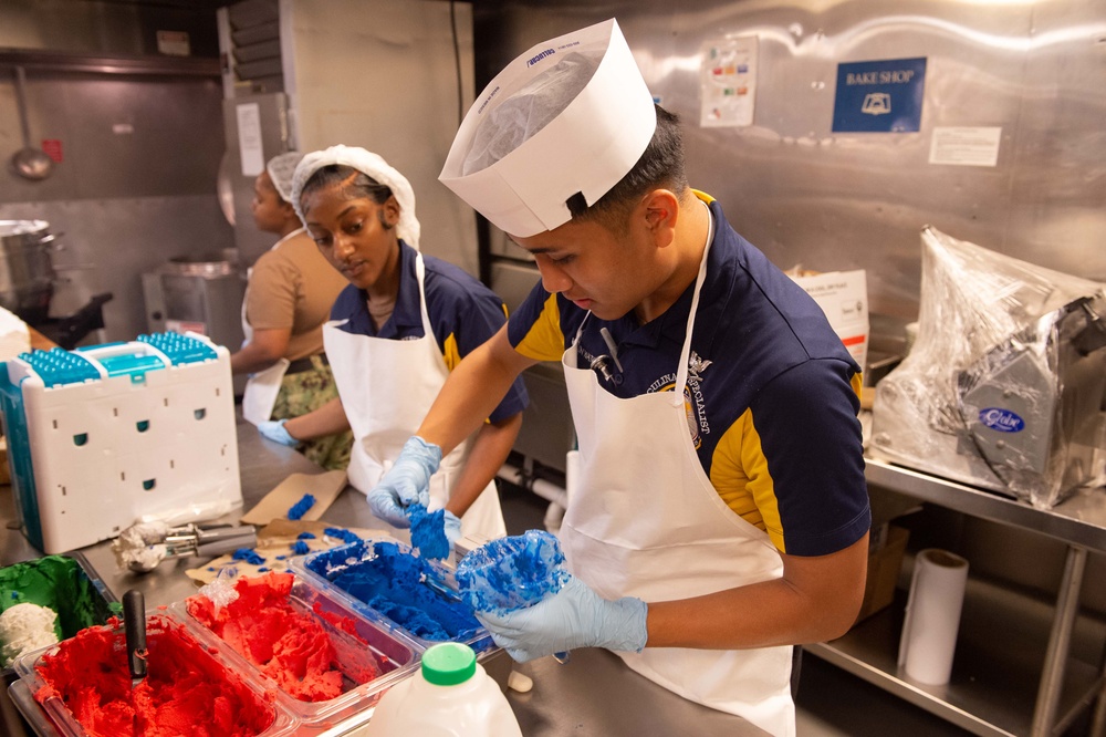 USS John C. Stennis (CVN 74) Sailors decorate 249th Navy birthday cake