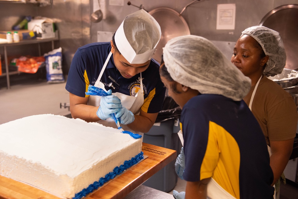 USS John C. Stennis (CVN 74) Sailors decorate 249th Navy birthday cake