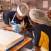 USS John C. Stennis (CVN 74) Sailors decorate 249th Navy birthday cake