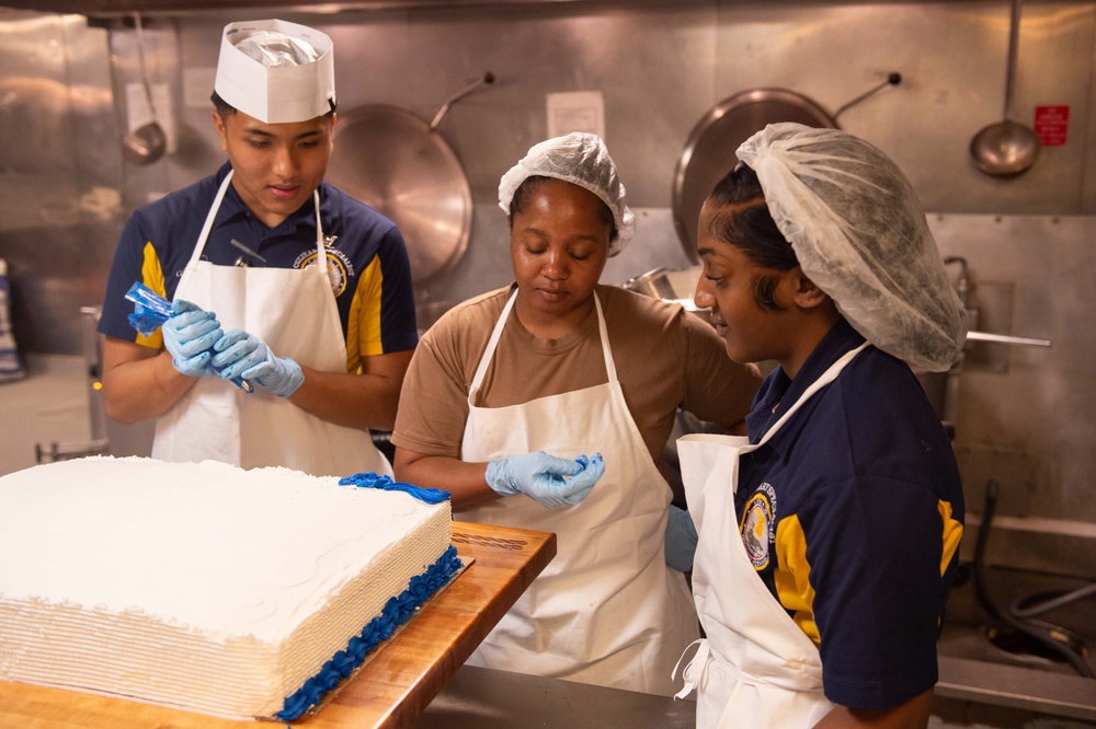 USS John C. Stennis (CVN 74) Sailors decorate 249th Navy birthday cake