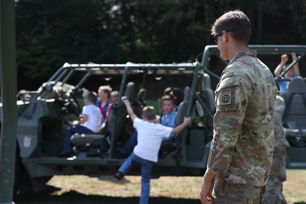 U.S. Army Soldiers assigned to the Bravo Company, 1st Battalion, 325th Airborne Infantry Regiment, 82nd Airborne Division, serve hot meals to local communities.