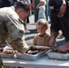 U.S. Army Soldiers assigned to the Bravo Company, 1st Battalion, 325th Airborne Infantry Regiment, 82nd Airborne Division, serve hot meals to local communities.
