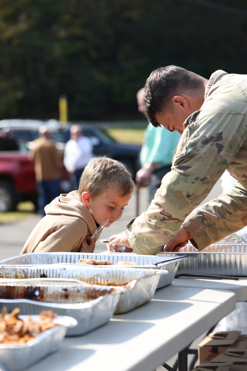 U.S. Army Soldiers assigned to the Bravo Company, 1st Battalion, 325th Airborne Infantry Regiment, 82nd Airborne Division, serve hot meals to local communities.