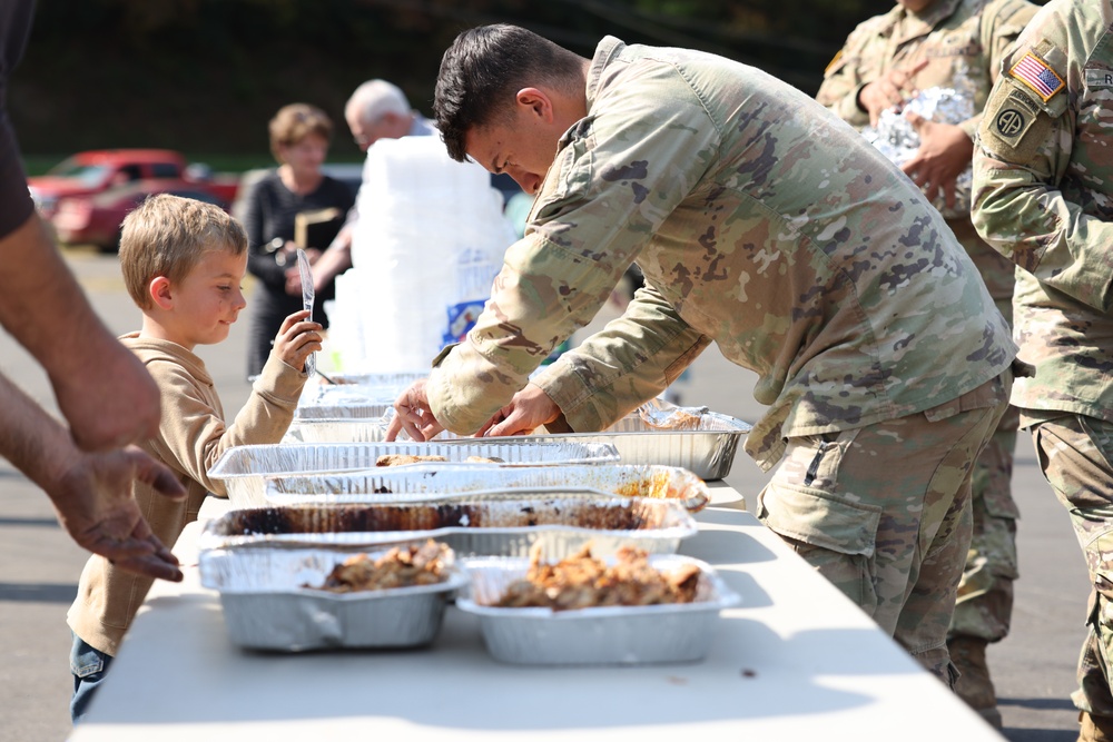 U.S. Army Soldiers assigned to the Bravo Company, 1st Battalion, 325th Airborne Infantry Regiment, 82nd Airborne Division, serve hot meals to local communities.