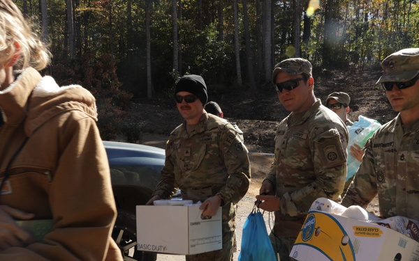 U.S. Army Soldiers assigned to the Bravo Company, 1st Battalion, 325th Airborne Infantry Regiment, 82nd Airborne Division, serve hot meals to local communities.
