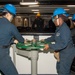 Sailors Turn the Break Wheel to Lower the Anchor