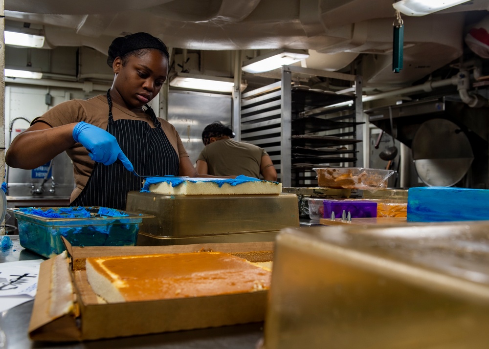 A Culinary Specialist Decorates a Cake in the Bake Shop