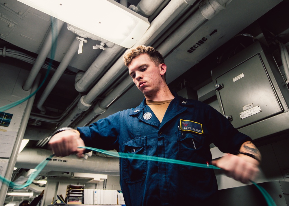 Information Systems Technicians install network cables aboard USS George Washington