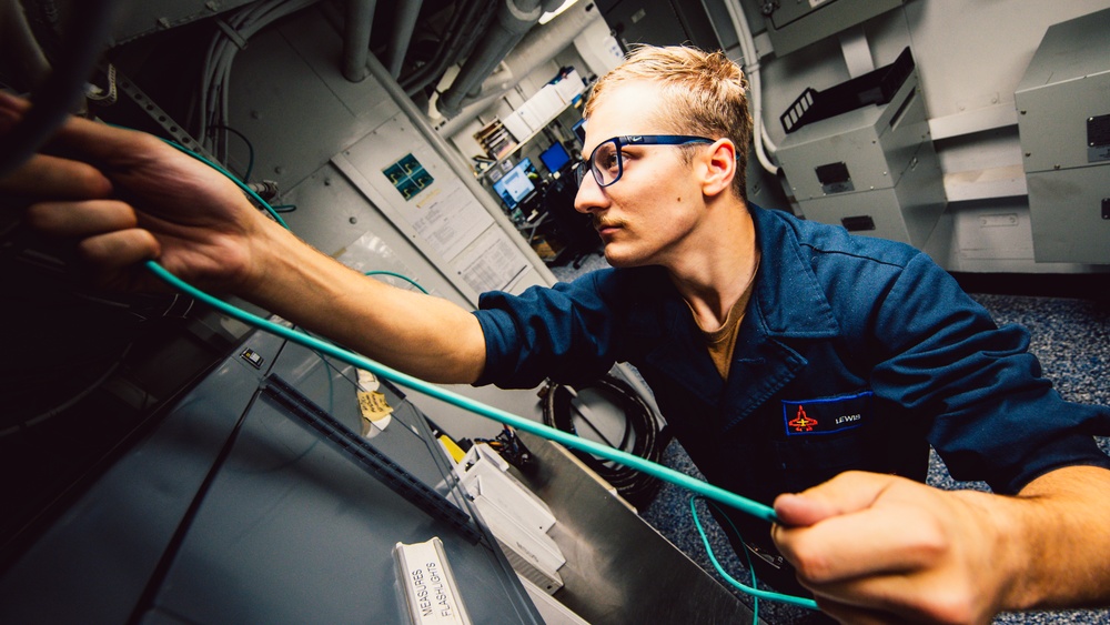 Information Systems Technicians install network cables aboard USS George Washington