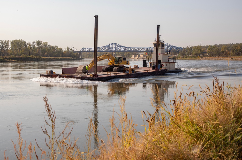 USACE heavy equipment operator scoops riprap along Missouri River