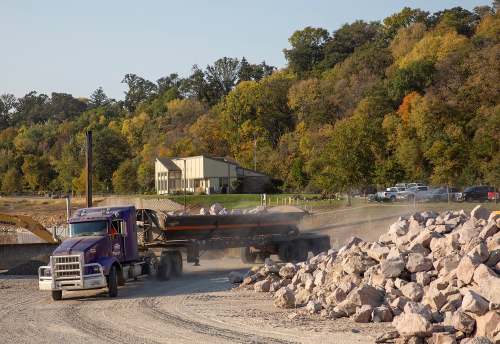 USACE heavy equipment operator scoops riprap along Missouri River