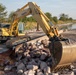 USACE heavy equipment operator scoops riprap along Missouri River