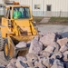 USACE heavy equipment operator scoops riprap along Missouri River