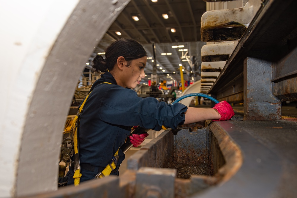 Aviation Ordnanceman performs maintenance on a Weapons Elevator