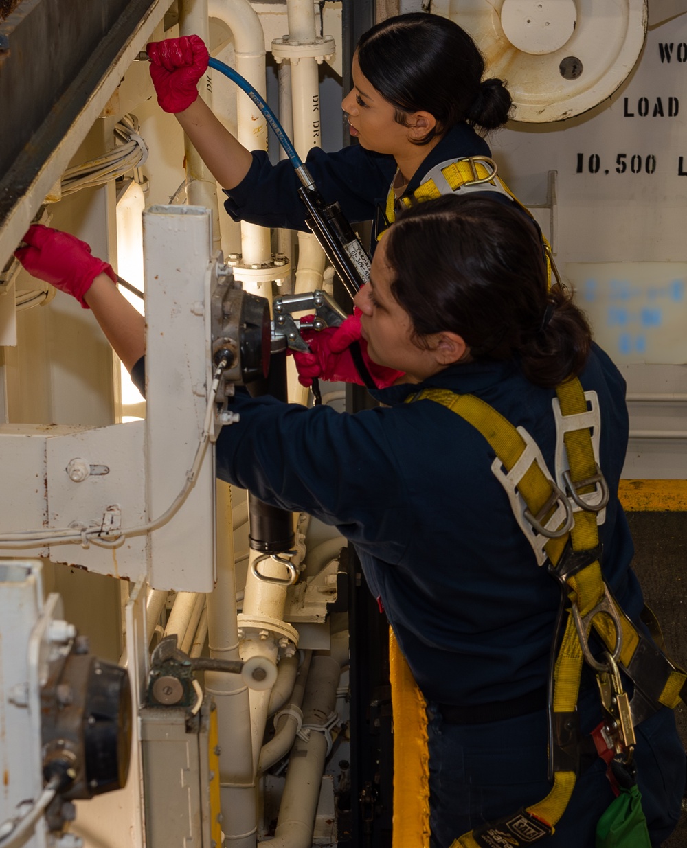 Sailors Perform Maintenance on a Weapons Elevator