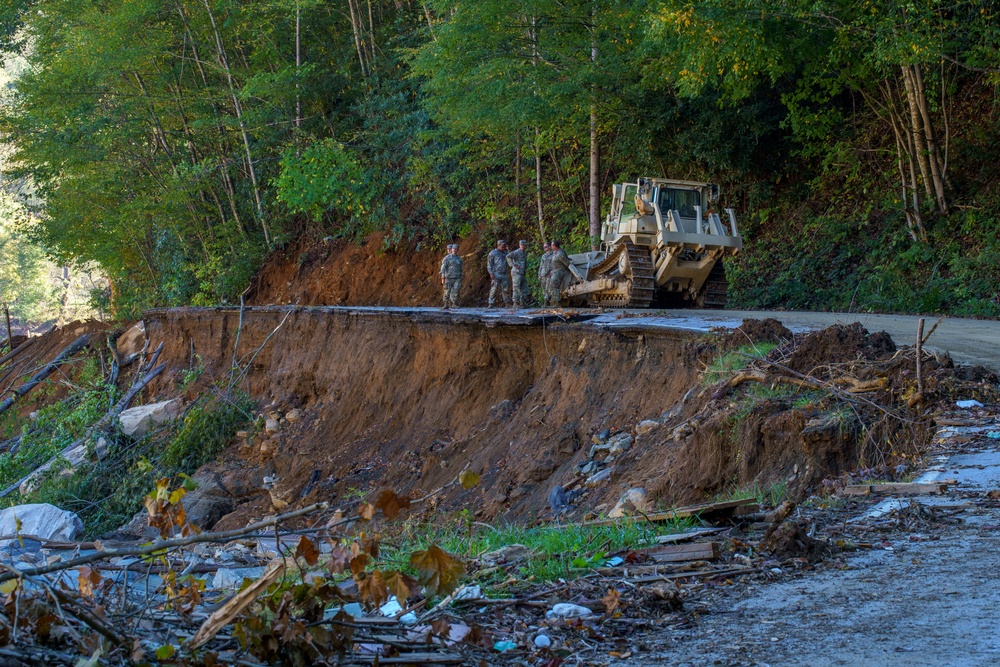 North Carolina National Guard Soldiers reinforce a temporary dirt roadway