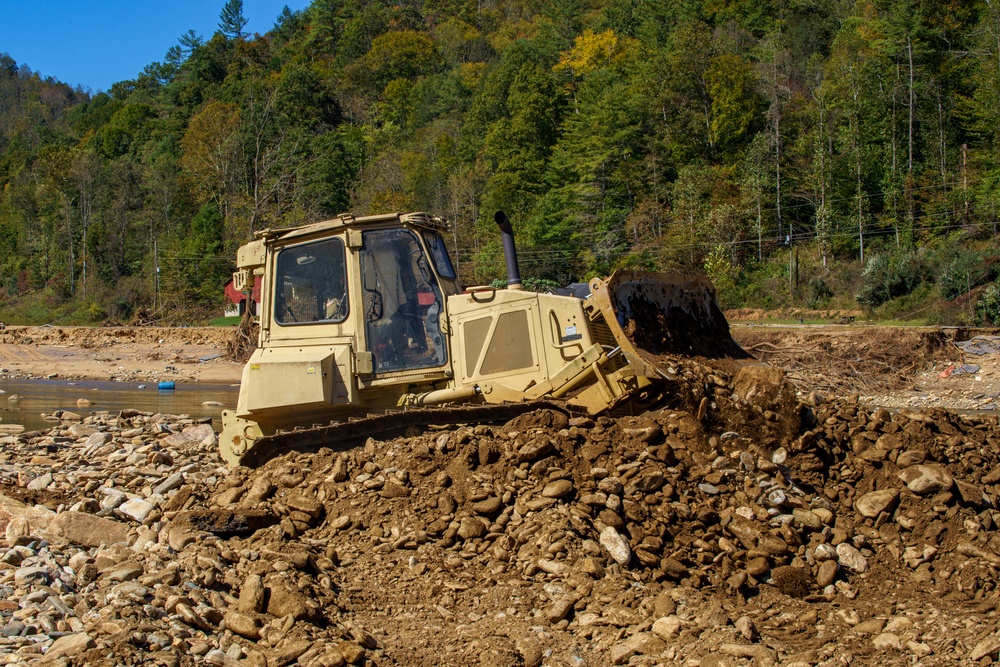 North Carolina National Guard Soldiers reinforce a temporary dirt roadway