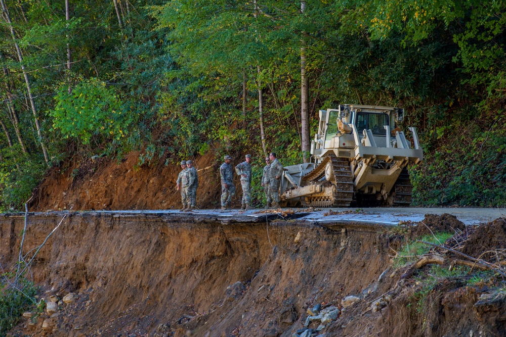 North Carolina National Guard Soldiers reinforce a temporary dirt roadway