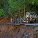 North Carolina National Guard Soldiers reinforce a temporary dirt roadway