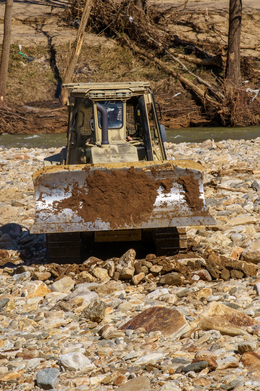 North Carolina National Guard Soldiers reinforce a temporary dirt roadway