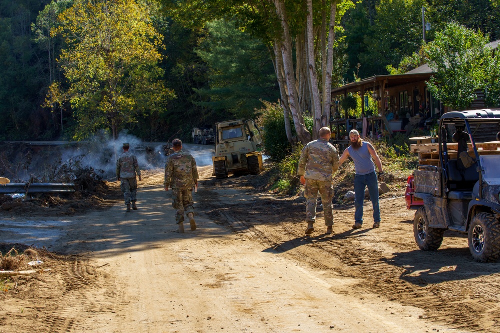 North Carolina National Guard Soldiers reinforce a temporary dirt roadway