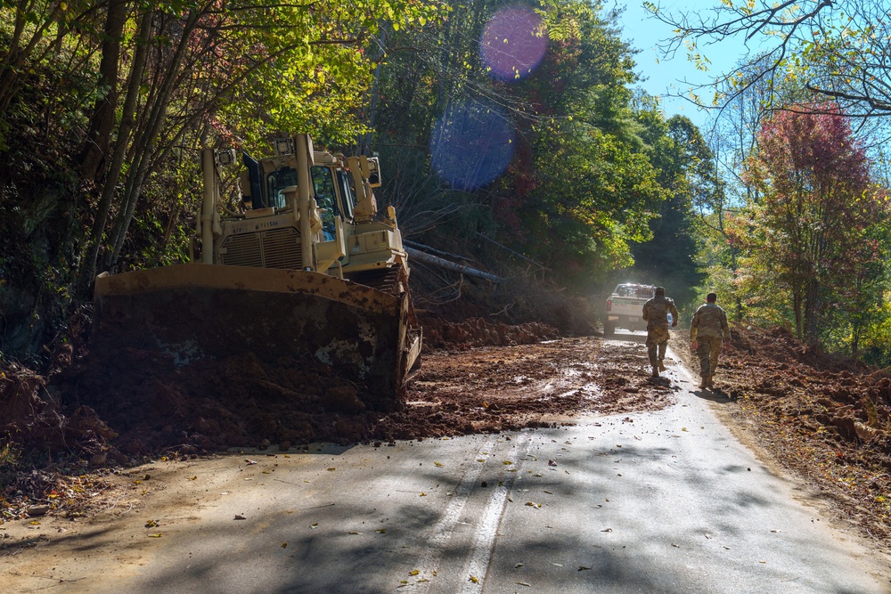 North Carolina National Guard Soldiers reinforce a temporary dirt roadway