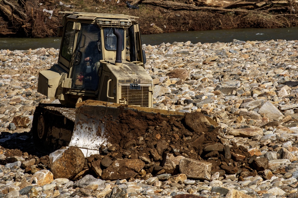 North Carolina National Guard Soldiers reinforce a temporary dirt roadway