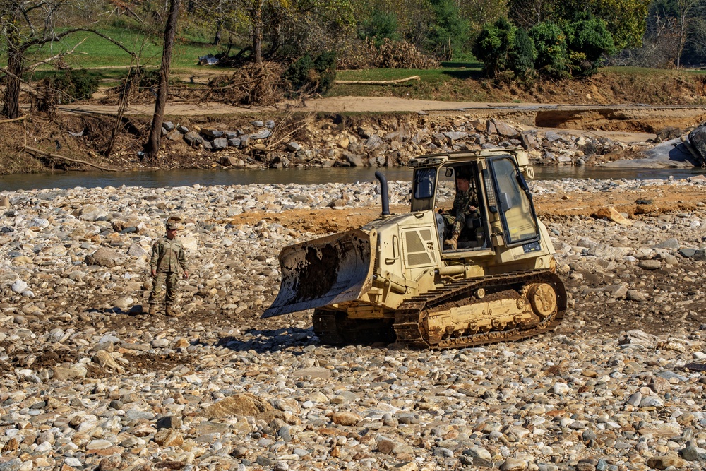 North Carolina National Guard Soldiers reinforce a temporary dirt roadway