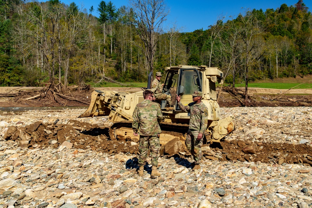North Carolina National Guard Soldiers reinforce a temporary dirt roadway