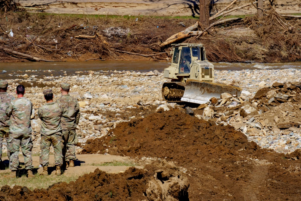 North Carolina National Guard Soldiers reinforce a temporary dirt roadway