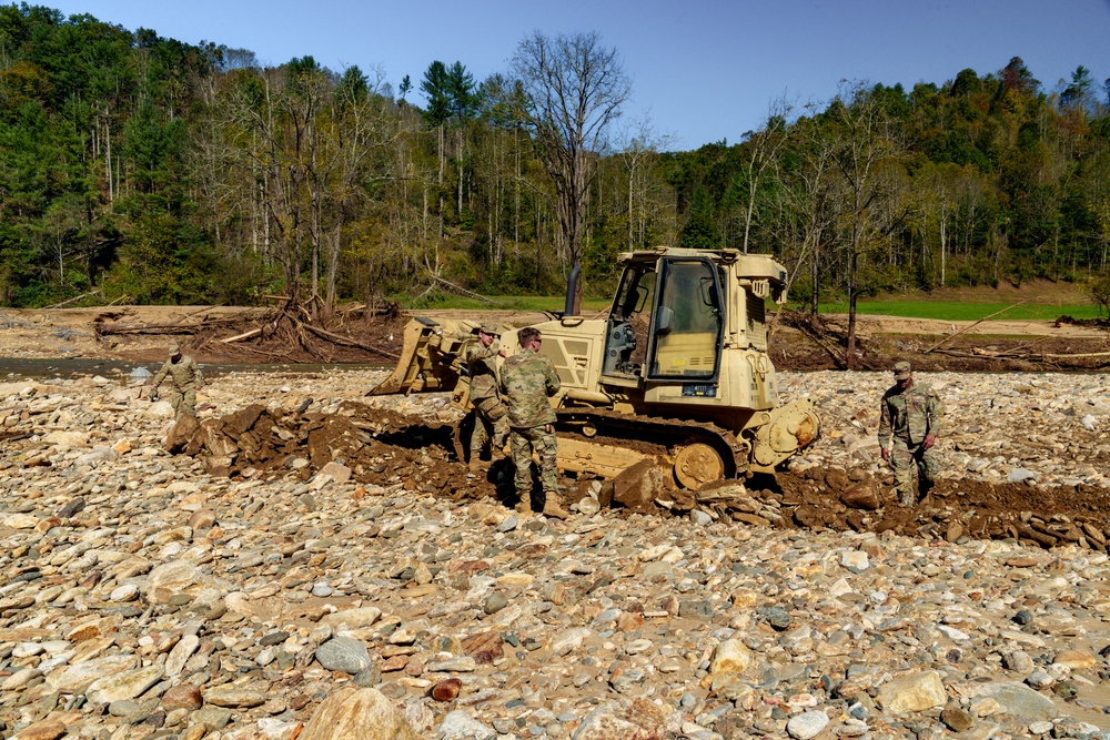 North Carolina National Guard Soldiers reinforce a temporary dirt roadway