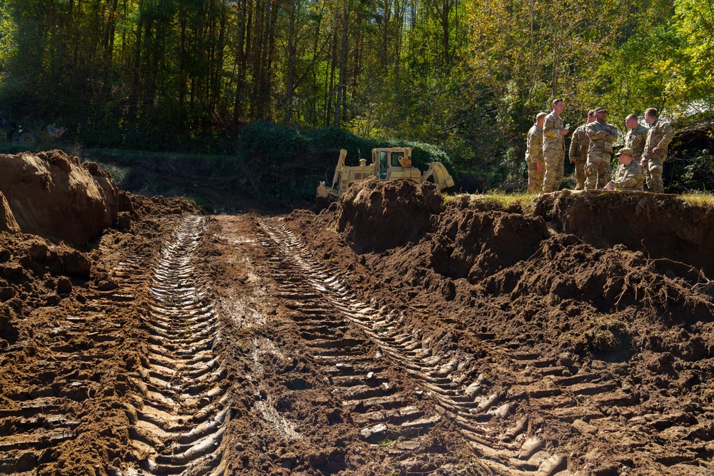 North Carolina National Guard Soldiers reinforce a temporary dirt roadway