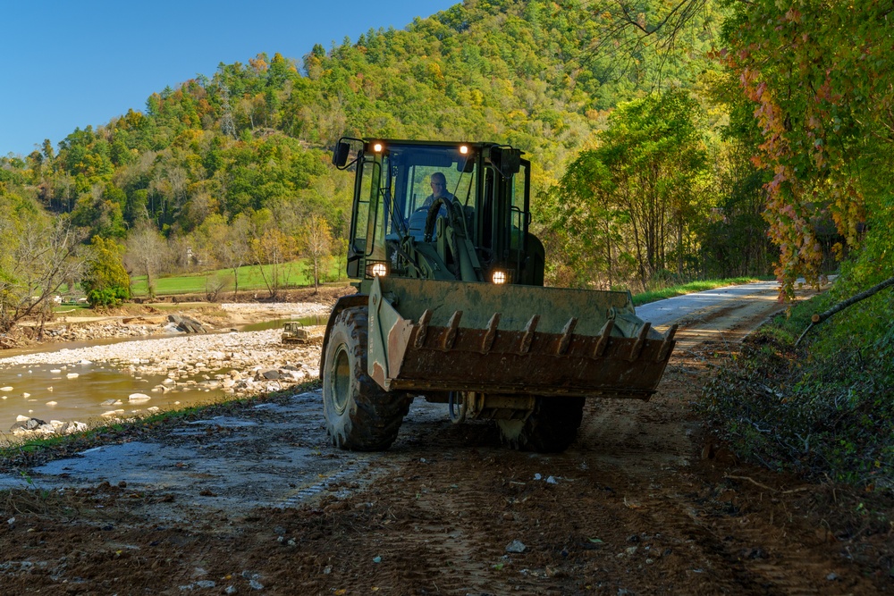North Carolina National Guard Soldiers reinforce a temporary dirt roadway