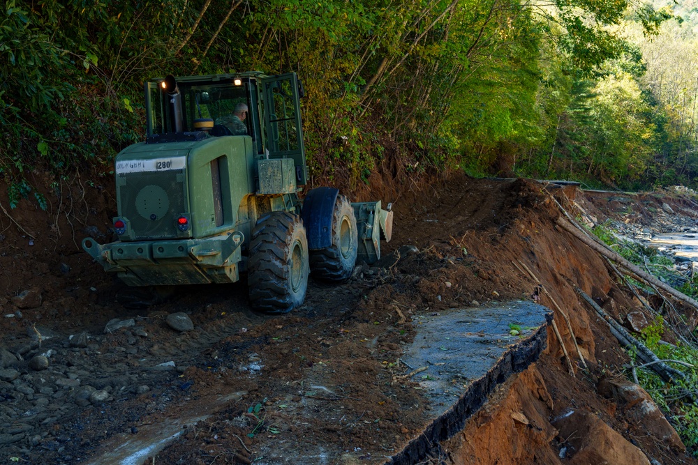 North Carolina National Guard Soldiers reinforce a temporary dirt roadway