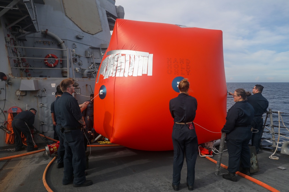 Sailors aboard the USS Howard make preparations for a gunnery exercise during Sama Sama 2024