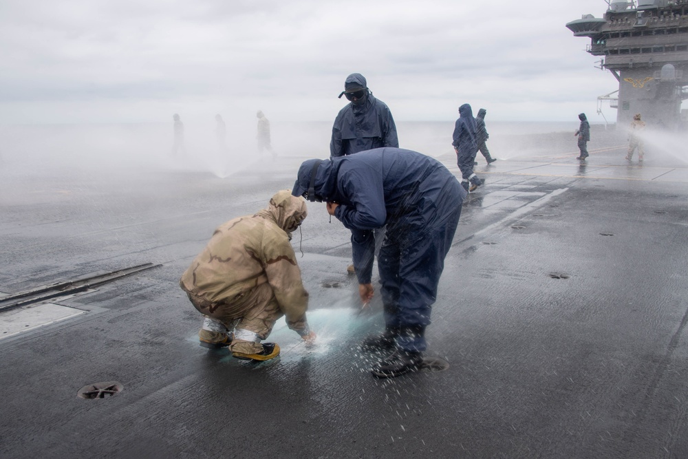 USS Carl Vinson (CVN 70) Sailors Conduct a Counter-Measure Washdown on the Flight Deck