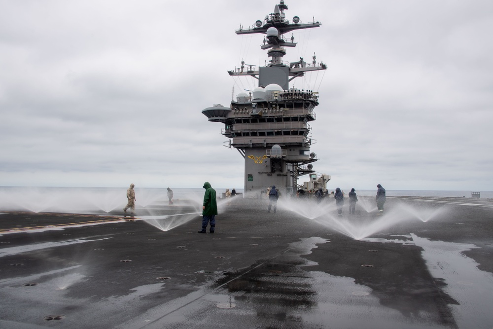 USS Carl Vinson (CVN 70) Sailors Conduct a Counter-Measure Washdown on the Flight Deck